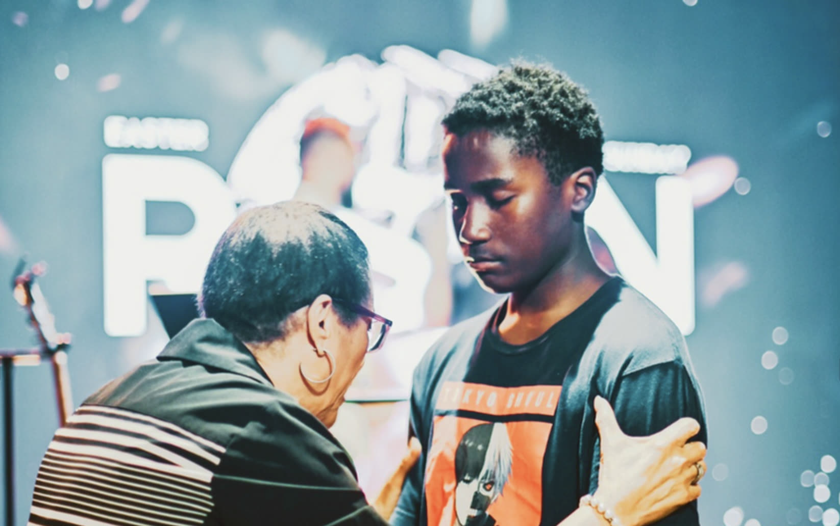 A member of The Pointe Church praying with another